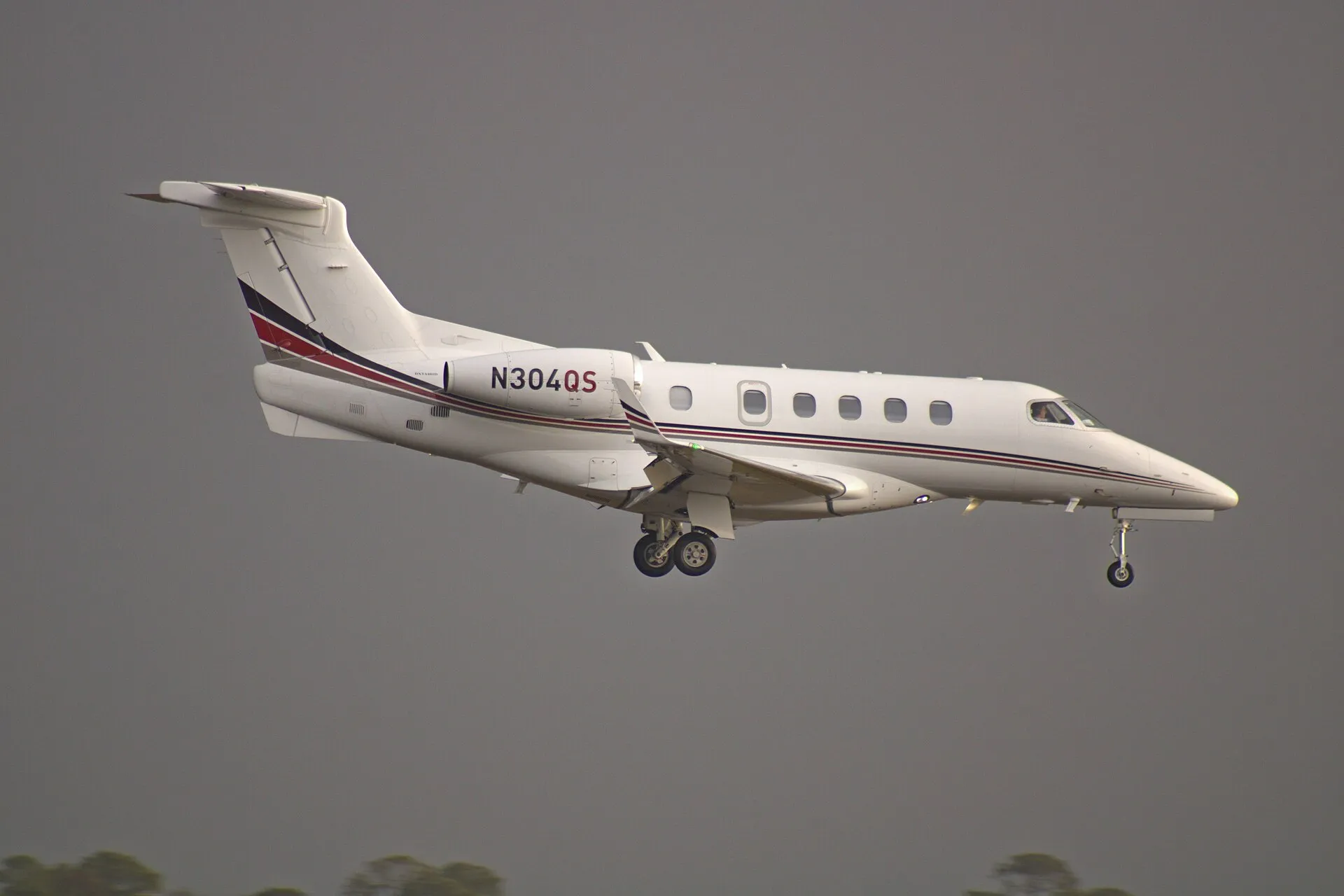A Phenom 300E in service, photographed from the side